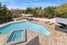 View of swimming pool featuring a pool with connected hot tub and a wooden deck