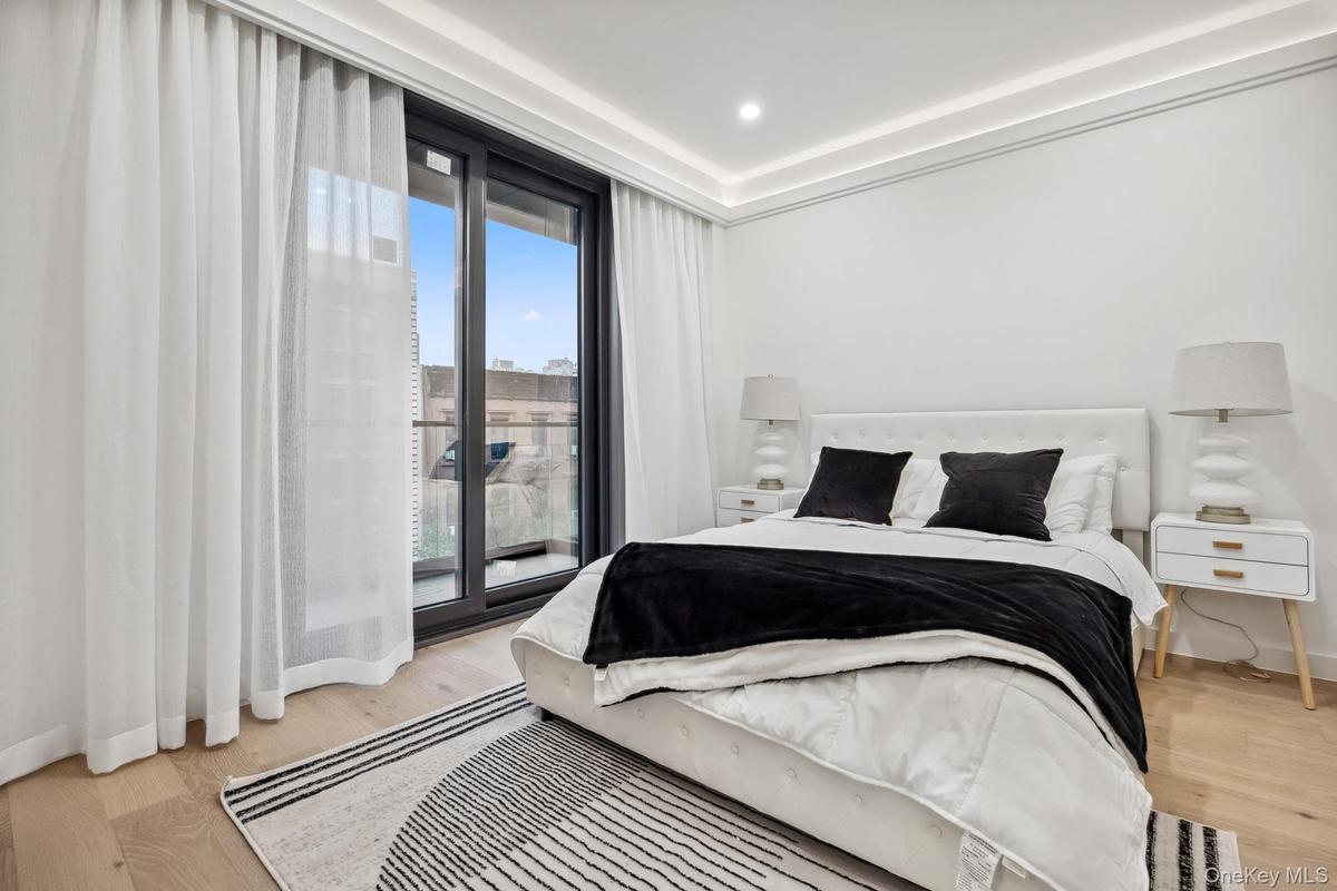 Bedroom featuring light wood-type flooring, baseboards, access to outside, and recessed lighting