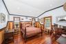 Bedroom featuring a wainscoted wall, recessed lighting, hardwood / wood-style flooring, lofted ceiling, and ornamental molding