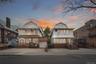 Front exterior elevation of 37-47 76th Street, Jackson Heights, NY 11372, featuring a three-family residence with a private driveway, attached garage,