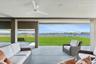 Sunroom / solarium featuring a water view, outdoor lounge area, and a ceiling fan