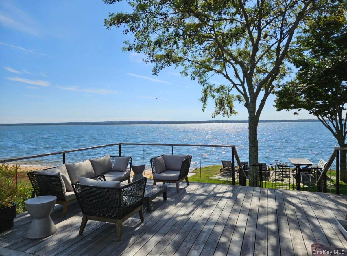 Deck with a water view and an outdoor living space