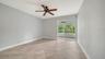 Guest bedroom also features floor to ceiling sliders leading to the lanai.