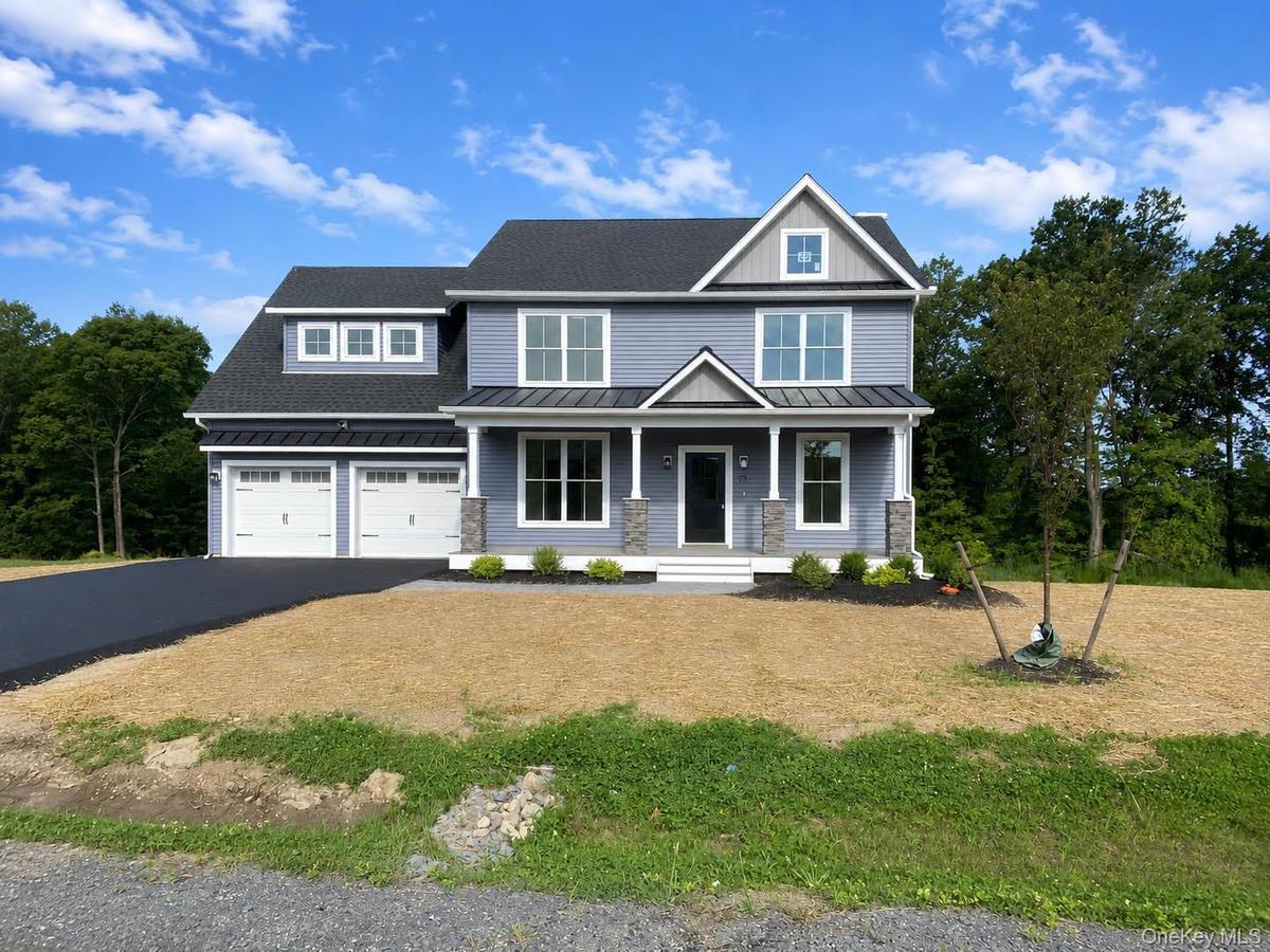 Beautiful new construction ready for occupancy, showcasing the home's completed exterior, welcoming covered front porch, two-car garage and modern arc