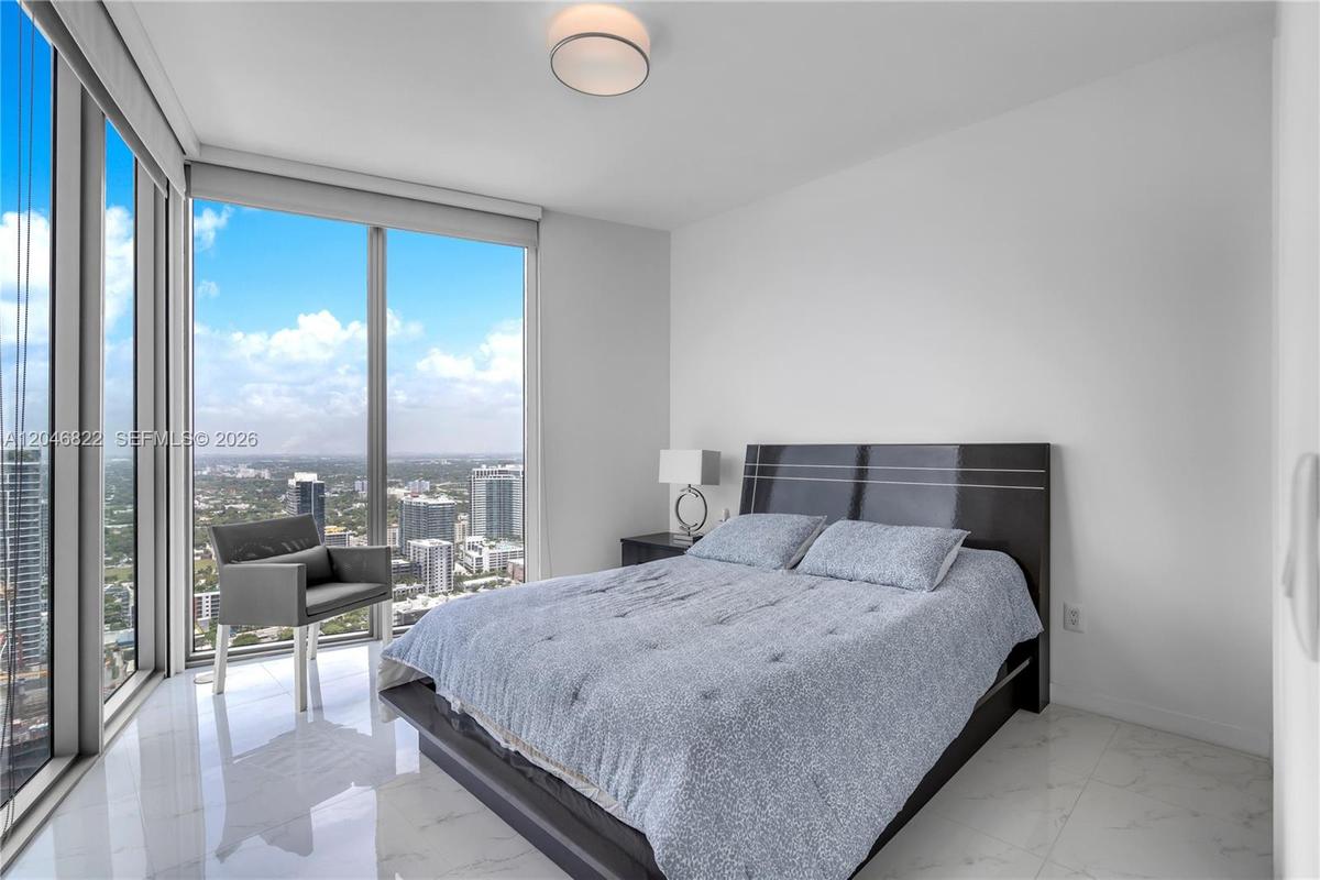 Guest bedroom with corner windows and sweeping city views
