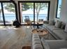 Living area featuring a water view, a wood stove, hardwood / wood-style floors, and a wealth of natural light
