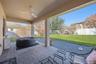 Large covered paved lanai overlooks the fully fenced backyard