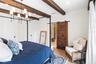 Primary Bedroom and sitting area facing decorative Barn door to Bathroom
