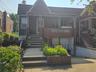 View of front of house with a porch and brick siding
