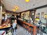 Community bar area featuring an ornate ceiling and brick wall