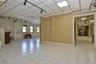 Spare room with rail lighting, a paneled ceiling, and baseboards