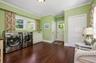 large laundry room, mudroom, storage closets, bathroom and side access