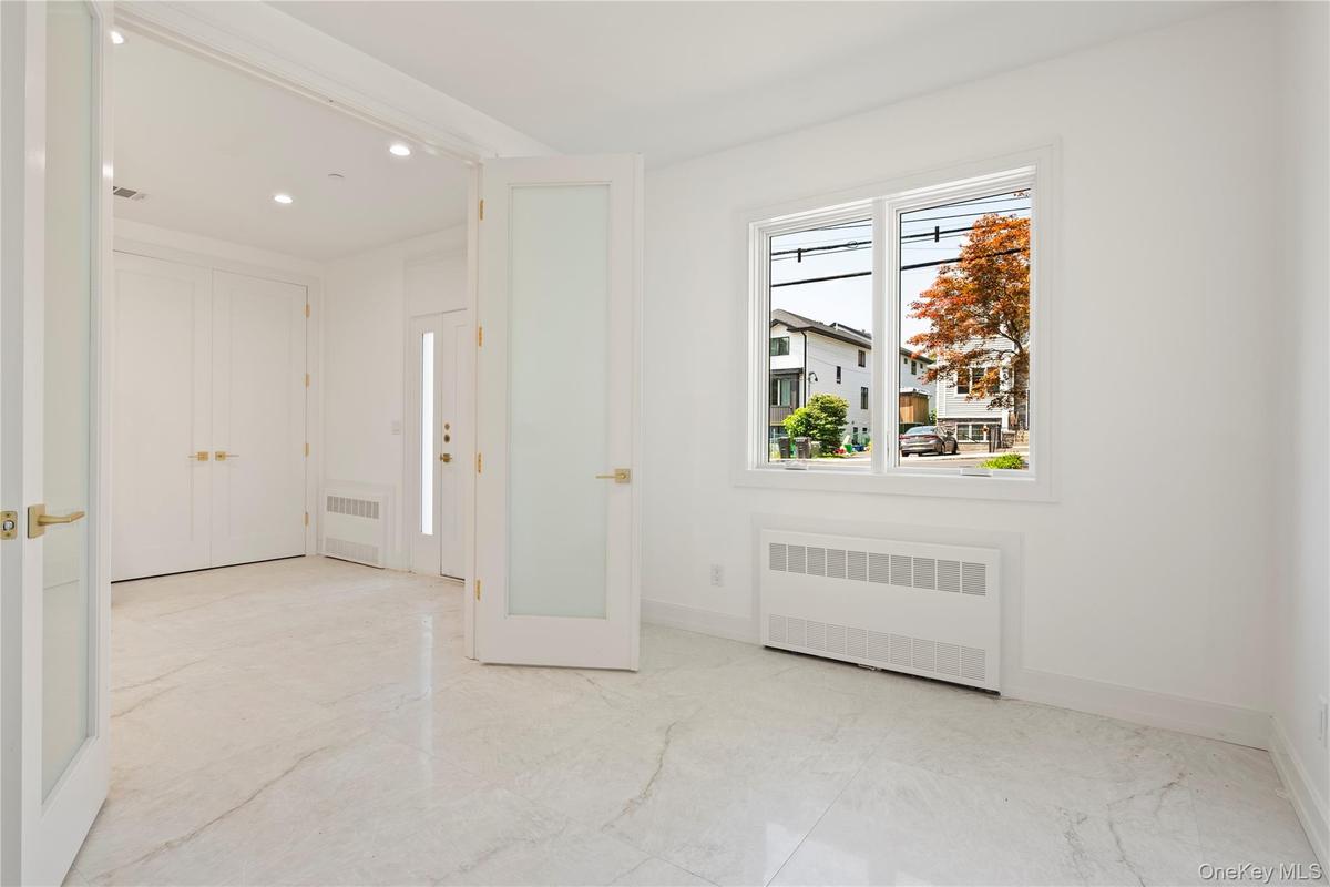 Foyer entrance with radiator and recessed lighting