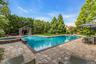 L-Shaped tiled gunite saltwater gas heated pool, with attached circular in-ground spa