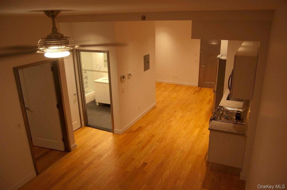 Hall featuring light wood finished floors and electric panel