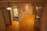 Hall featuring light wood finished floors and electric panel