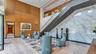 Inviting lobby seating offers a comfortable place to relax, with staircase leading to the building's exceptional amenities
