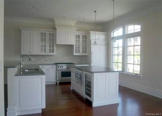 Gourmet eat in kitchen... plenty of cabinetry... high end SS appliances... microwave & beverage center built into center island... large built in Fren