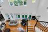 Living room with a high ceiling, french doors, hardwood / wood-style flooring, and stairs