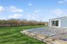 Wooden terrace featuring a lawn