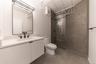 Bathroom with vanity, a stall shower, and concrete flooring