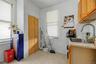 White walls with a window, stainless steel refrigerator, and stainless steel range