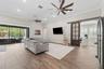 Spacious living room with dual oversized fans.