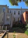 Back of house featuring brick siding