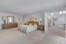 Spacious Primary bedroom featuring light-colored carpeting and recessed lighting
