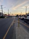 View of asphalt street with street lighting, sidewalks, and curbs