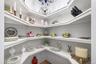 Very large built-in pantry closet with lots of  shelving with white finishes