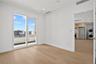 Unfurnished room with light wood-style flooring, stacked washer and clothes dryer, and recessed lighting