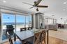 Dining area with a ceiling fan, light wood finished floors, recessed lighting, and a water view