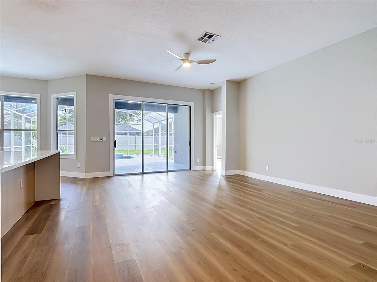 bright open-concept layout with new vinyl flooring, a fully renovated kitchen