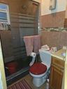 Bathroom with a stall shower, vanity, tile patterned floors, and tile walls