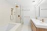 Bathroom featuring a shower stall, light tile patterned flooring, a garden tub, double vanity, and recessed lighting