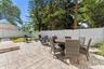 Fully fenced in backyard with a screened-in porch, paver patio for entertaining, professional landscaping, and irrigation system