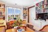 Living area featuring crown molding and dark wood finished floors