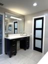 Make up vanity and opaque glass door leading to the private toilet