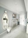 Sitting room with baseboards and light marble finish floors