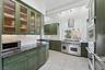Kitchen with light tile patterned flooring, dark stone counters, green cabinets, island range hood, and stainless steel appliances