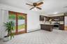 Kitchen area featuring a breakfast bar with light-toned countertops, dark wood-finish cabinetry, and stainless steel appliances