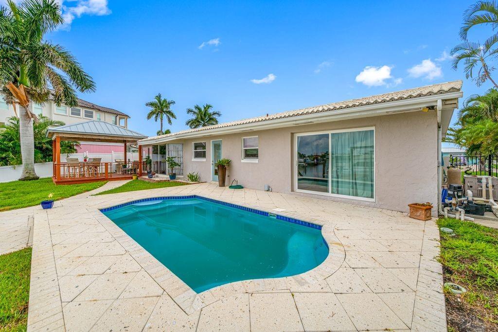 Pool with seashell pavers - Slider is access to primary suite - Covered deck off dining room