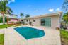 Pool with seashell pavers - Slider is access to primary suite - Covered deck off dining room
