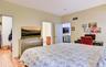 Legal accessory apartment: Bedroom featuring light yellow walls and wood flooring