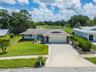 Front view of 1207 Timberbrooke Dr showcasing exceptional curb appeal and well-maintained landscape.