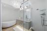 Primary bathroom with luxury finishes in Wellington FL rental home with soaking tub and shower.