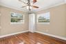 The fourth bedroom features BUILT-IN CABINETRY, making it an ideal home office or creative workspace.