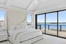 Bedroom featuring a water view, access to outside, and ceiling fan