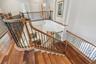 Beautiful custom architectural railings and shining solid wood floors.
